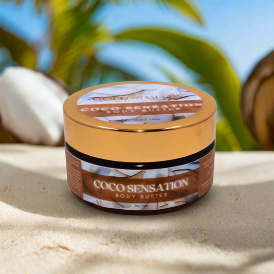 Coco Sensation body butter jar on sand with coconut and palm leaves in the background